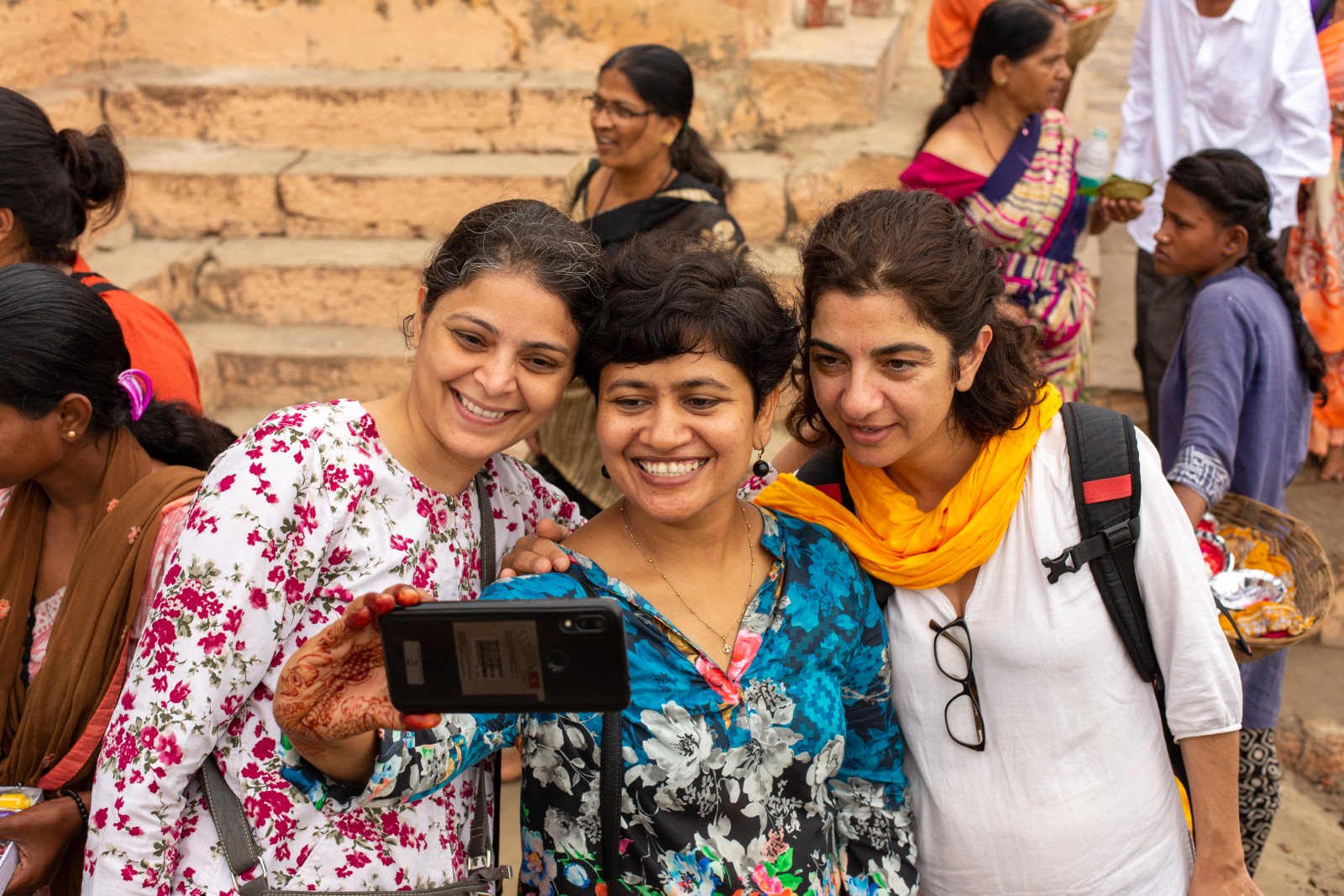 Three women pose for a selfie.